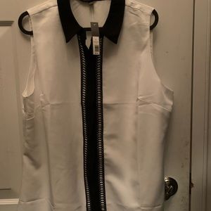 Sleeveless blouse with black trim detail.